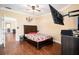 Comfortable bedroom featuring hardwood floors, ceiling fan and doorway leading to a dining and kitchen at 2161 Peachtree Ne Rd # 402, Atlanta, GA 30309