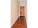 Hallway with wood-look floors leading to a wood front door at 2161 Peachtree Ne Rd # 402, Atlanta, GA 30309