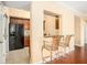 Kitchen featuring dark cabinets, tile floors and bar seating with a view of living area at 2161 Peachtree Ne Rd # 402, Atlanta, GA 30309