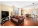 Living area with hardwood floors and a leather sofa with a view of dining area and balcony at 2161 Peachtree Ne Rd # 402, Atlanta, GA 30309