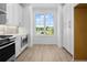 Modern kitchen with stainless steel appliances, white cabinets, and hardwood floors at 2832 Evanshire Ave # 112, Duluth, GA 30096