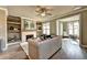 Bright living room with fireplace, hardwood floors, ceiling fan, and decor shelving at 2832 Evanshire Ave # 112, Duluth, GA 30096