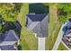Overhead view of a home showcasing the roof, driveway, and surrounding greenery at 4066 Wild Orchid Ln, Loganville, GA 30052