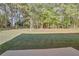 View of a level backyard featuring a grassy lawn and wooded border at 4066 Wild Orchid Ln, Loganville, GA 30052