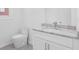Modern bathroom featuring granite countertop, sink, toilet and white cabinets at 4066 Wild Orchid Ln, Loganville, GA 30052