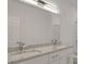 Elegant bathroom with double sink vanity, granite counters, and a large mirror at 4066 Wild Orchid Ln, Loganville, GA 30052