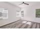 Bedroom featuring a ceiling fan and two windows with a view of the backyard at 4066 Wild Orchid Ln, Loganville, GA 30052