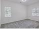Spacious bedroom with plush carpet and a large window with bright natural light at 4066 Wild Orchid Ln, Loganville, GA 30052