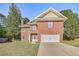 Beautiful two-story brick home featuring a spacious driveway and a manicured lawn at 4066 Wild Orchid Ln, Loganville, GA 30052