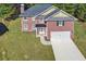 Beautiful two-story brick home with attached garage and well-manicured lawn at 4066 Wild Orchid Ln, Loganville, GA 30052