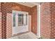 Inviting front entrance with decorative glass door and classic red brick facade at 4066 Wild Orchid Ln, Loganville, GA 30052