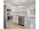 Modern kitchen featuring white cabinets, stainless steel appliances, and granite countertops at 4066 Wild Orchid Ln, Loganville, GA 30052