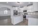 Modern kitchen features white cabinets, granite countertops, and stainless steel appliances at 4066 Wild Orchid Ln, Loganville, GA 30052