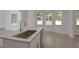 Bright kitchen with a view, featuring granite countertops and a stainless steel dishwasher at 4066 Wild Orchid Ln, Loganville, GA 30052