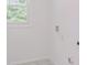 Bright, all white laundry room with modern electrical and plumbing hookups at 4066 Wild Orchid Ln, Loganville, GA 30052