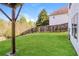Spacious backyard features a lush lawn and wooden fence at 4437 James Wade Dr, Snellville, GA 30039