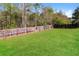 Green backyard with grass and a wooden fence at 4437 James Wade Dr, Snellville, GA 30039