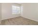 Bedroom featuring a large window, neutral walls, plush carpeting, and white baseboards at 4437 James Wade Dr, Snellville, GA 30039
