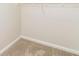 Walk in closet with carpeting, shelving, and white trim against neutral walls at 4437 James Wade Dr, Snellville, GA 30039