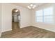Dining area with modern lighting, hardwood floors, and large windows creating a bright and inviting atmosphere at 4437 James Wade Dr, Snellville, GA 30039