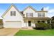 Charming two-story home with a well-maintained lawn, attached two-car garage, and a welcoming front porch at 4437 James Wade Dr, Snellville, GA 30039