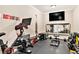 Well-equipped home gym features Peloton bike, free weights, a mirror, and motivational wall decal at 4922 Summer Wind Dr, Buford, GA 30519