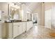 Bright bathroom boasts double sinks with granite countertop and tiled flooring, plus access to the main bedroom at 4922 Summer Wind Dr, Buford, GA 30519