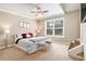 Spacious bedroom with a large window providing ample natural light, complemented by a ceiling fan and cozy decor at 4922 Summer Wind Dr, Buford, GA 30519