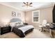 Well-lit bedroom with a desk and chair setup, offering a comfortable and functional space for work or relaxation at 4922 Summer Wind Dr, Buford, GA 30519