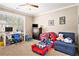 Comfortable carpeted bedroom offers ample natural light, desk area, TV, and playful decor at 4922 Summer Wind Dr, Buford, GA 30519