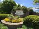 Attractive community entrance sign with well-maintained landscaping and colorful flowers at 4922 Summer Wind Dr, Buford, GA 30519