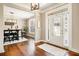 Bright foyer with hardwood floors, decorative rug, and a view of the dining room at 4922 Summer Wind Dr, Buford, GA 30519