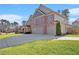 Well-maintained two-story brick home with an attached two-car garage and large driveway at 4922 Summer Wind Dr, Buford, GA 30519