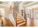 An elegant foyer with hardwood floors, wood stairs, and an iron railing leading to the second story at 4922 Summer Wind Dr, Buford, GA 30519