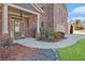 Welcoming brick home with manicured front yard and walkway leading to the front door at 4922 Summer Wind Dr, Buford, GA 30519