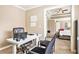 This home office features neutral paint, and is furnished with a standard desk and black office chairs at 4922 Summer Wind Dr, Buford, GA 30519