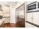 Close-up of a kitchen featuring stainless steel refrigerator, oven, and custom cabinets at 4922 Summer Wind Dr, Buford, GA 30519