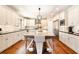 Spacious kitchen featuring a large central island with seating and modern lighting fixtures at 4922 Summer Wind Dr, Buford, GA 30519