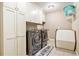 Efficient laundry room with modern washer and dryer, ample storage cabinets, and functional layout at 4922 Summer Wind Dr, Buford, GA 30519