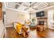 A sun-filled living room offers hardwood floors, a fireplace, and a decorative tray ceiling with fan at 4922 Summer Wind Dr, Buford, GA 30519