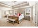 The primary bedroom features neutral paint, tray ceiling, carpet, and a tufted headboard at 4922 Summer Wind Dr, Buford, GA 30519