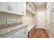 Organized mudroom with built-in bench, hooks, and storage, blending practicality with stylish design elements at 4922 Summer Wind Dr, Buford, GA 30519