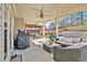 Inviting covered patio with a seating area, ceiling fan, and outdoor grill, perfect for relaxing and entertaining at 4922 Summer Wind Dr, Buford, GA 30519