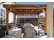 Outdoor pergola with string lights and a dining table, creating an inviting space for entertaining and relaxation at 4922 Summer Wind Dr, Buford, GA 30519
