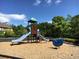 Community playground with a slide and spring rider on a wood chip ground cover at 4922 Summer Wind Dr, Buford, GA 30519