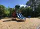Community playground with a slide and spring rider on a wood chip ground cover at 4922 Summer Wind Dr, Buford, GA 30519