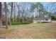 Spacious backyard with mature trees, offering privacy and shade at 5700 Tracy Dr, Mableton, GA 30126