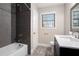 Modern bathroom features a shower with dark subway tile and decorative tile accents at 5700 Tracy Dr, Mableton, GA 30126