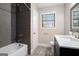 Renovated bathroom featuring gray tiled shower, new vanity, white toilet, and wood-look floors at 5700 Tracy Dr, Mableton, GA 30126
