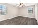 Spacious bedroom with new gray wood-look flooring, large windows, and ceiling fan at 5700 Tracy Dr, Mableton, GA 30126